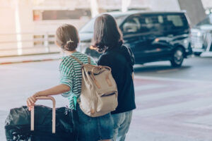 women waiting for their airport shuttle