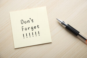 sticky note reminder that says don't forget